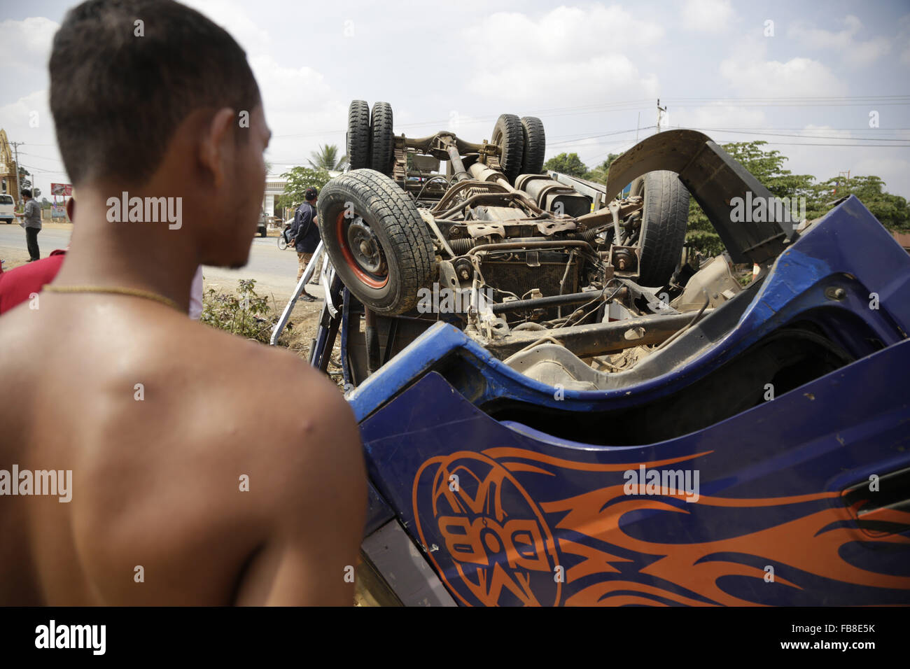 Phnom Penh Cambogia. Xii gen, 2016. Un uomo guarda il relitto di un carrello in Kampong Speu Provincia, Cambogia, Gennaio 12, 2016. Il numero di morti in una collisione tra due carrelli che trasportano i lavoratori di indumento in Cambogia occidentale è salito al 5, 68 altri sono stati feriti, secondo un Ministero del Lavoro della dichiarazione martedì. Credito: Sovannara/Xinhua/Alamy Live News Foto Stock