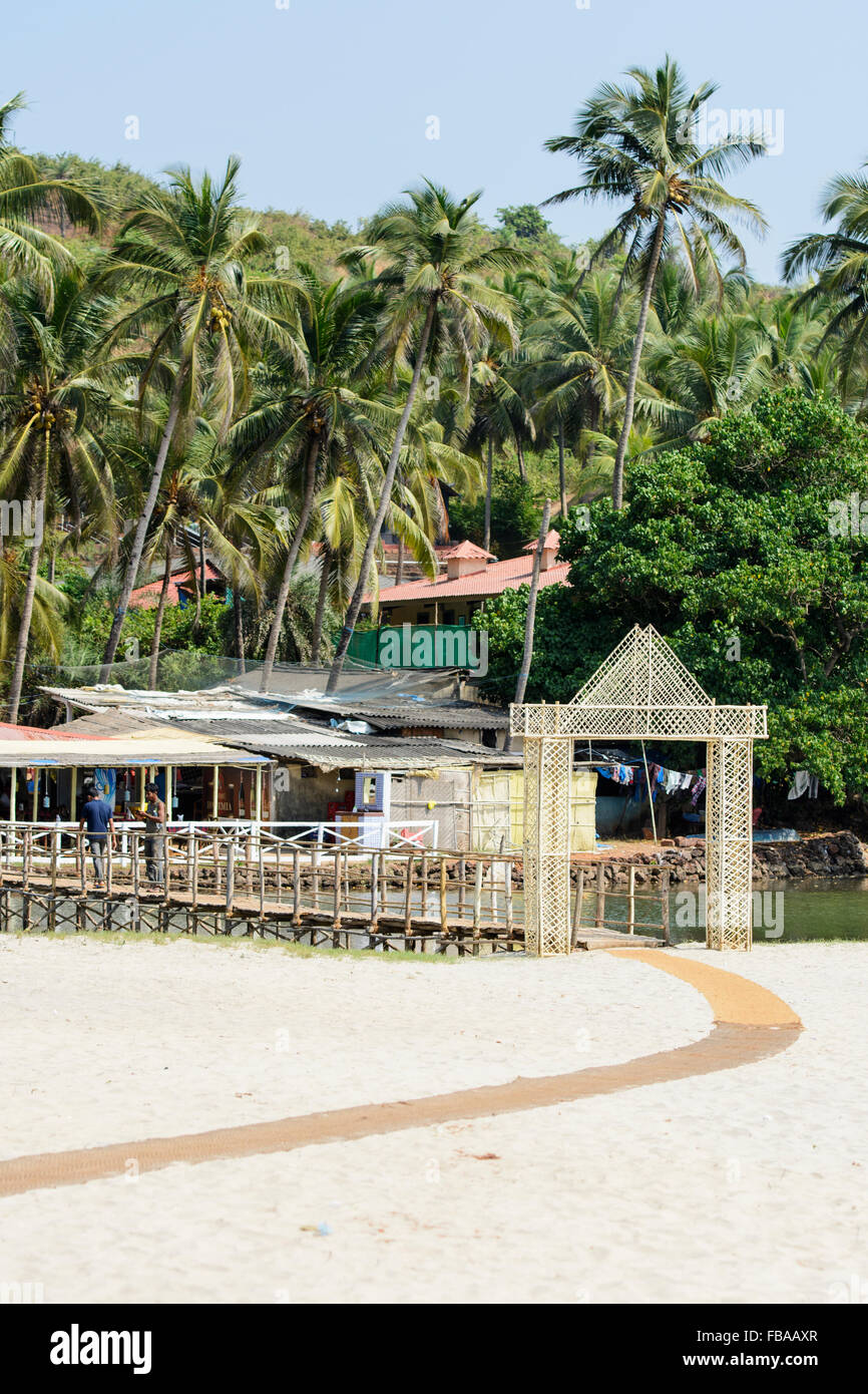 Ponte di legno che conduce alla spiaggia di Mandrem, Nord Goa, India Foto Stock