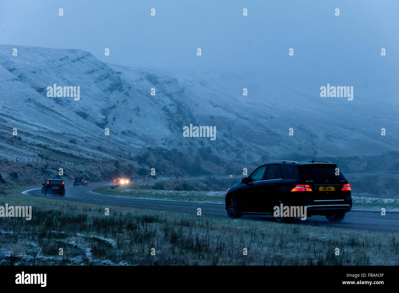 Brecon, Powys, Wales, Regno Unito. Il 13 gennaio, 2016. Il traffico negozia la A470 strada sopra il Brecon Beacons vicino a piani di bracci durante una tempesta di grandine e neve. Credito: Graham M. Lawrence/Alamy Live News. Foto Stock