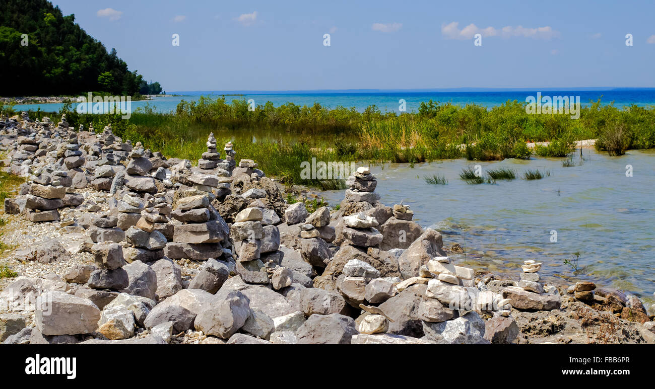 Sfondo costiere.Rocky lakeshore con centinaia di cairns lasciati dai turisti. Isola di Mackinaw, Michigan Foto Stock