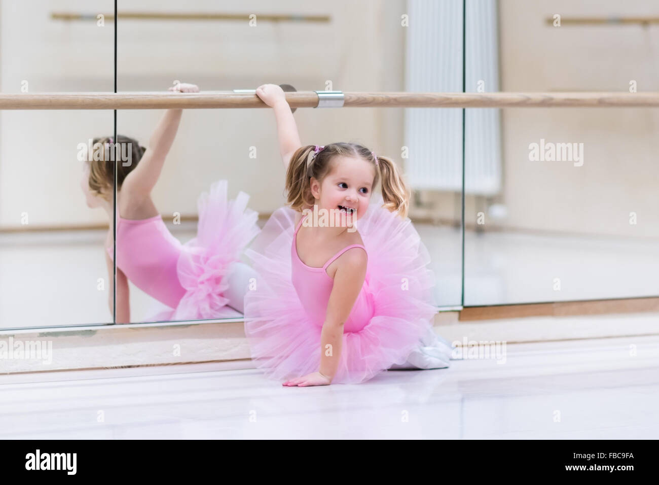 Little Ballerina ragazza in un rosa tutu. Adorabili bambini danza balletto classico in un studio di bianco. Bambini Danza. Foto Stock