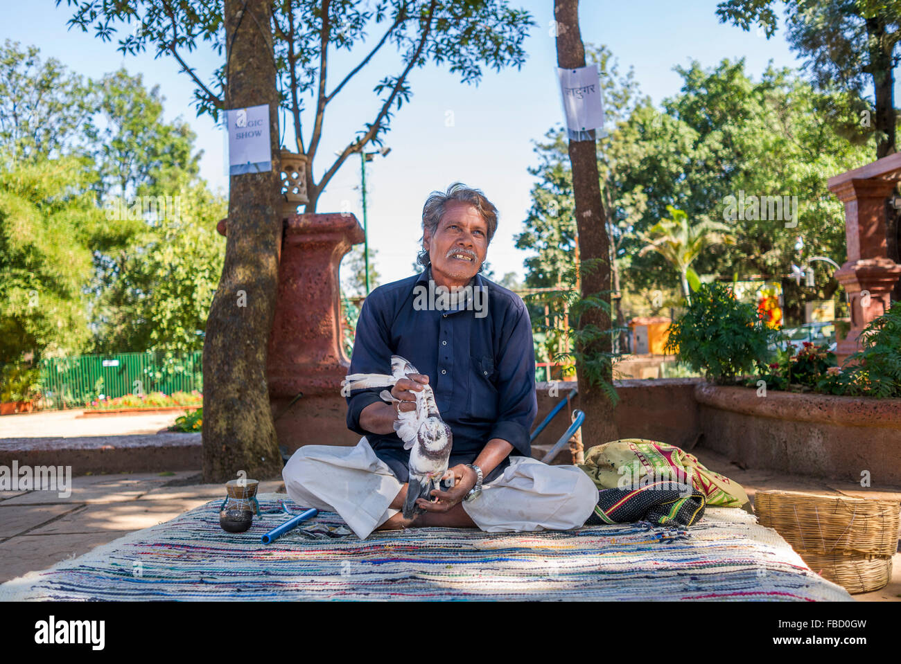 Mago indiano eseguendo il suo spettacolo presso i Ghati Occidentali, India. Foto Stock