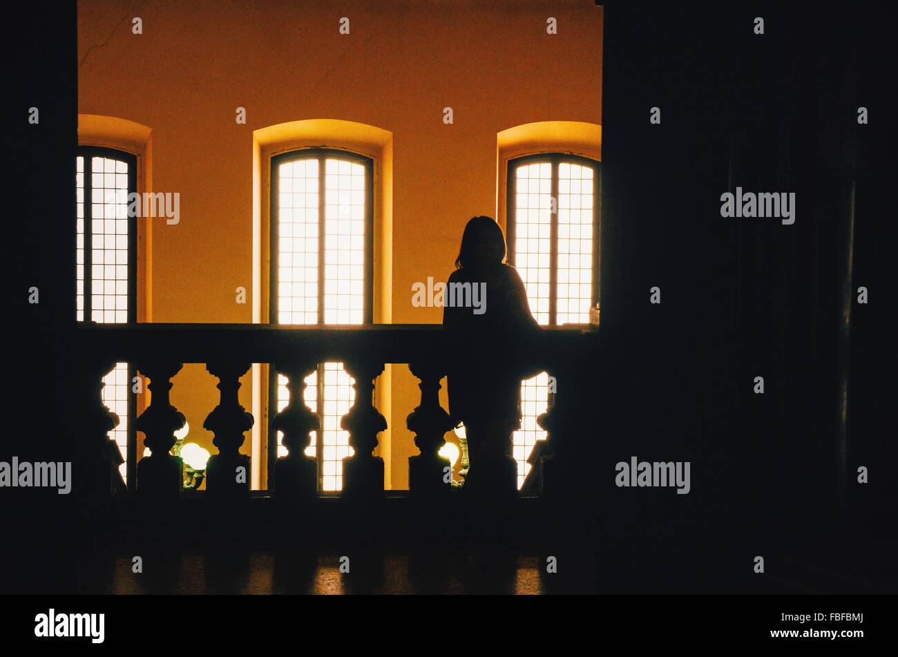 Silhouette a persona in piedi contro Windows Foto Stock