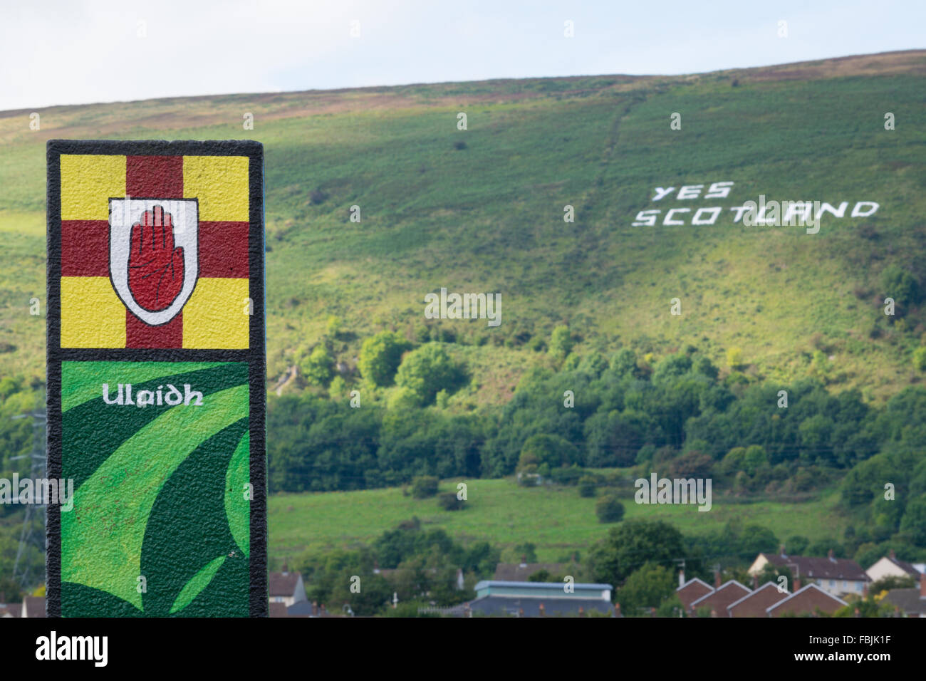 La provincia irlandese Ulster crest dipinta su un post a Belfast con sì Scozia sulla montagna nera Foto Stock