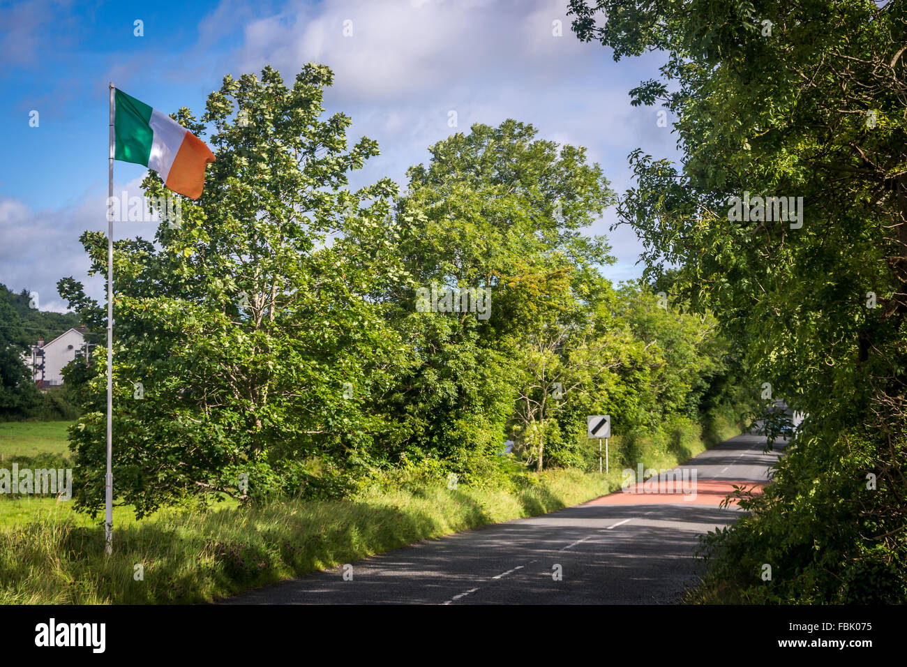 Un irlandese tricolore sventola all'entrata a Forkhill village di Armagh, Irlanda. Foto Stock