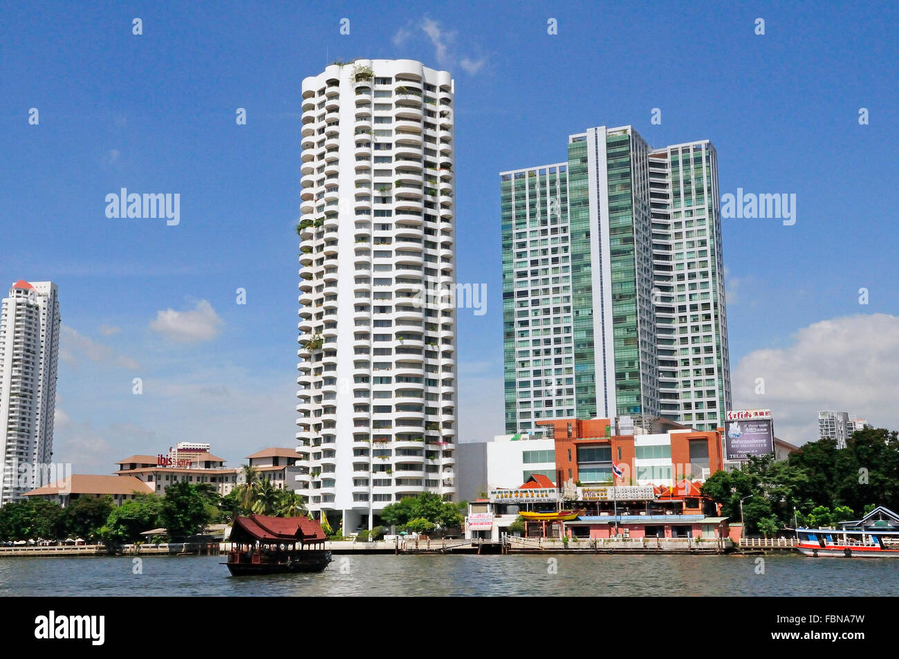 Il fiume Chao Phraya e il moderno skyline di Bangkok, Bangrak district, Bangkok, Thailandia, Sud Est asiatico Foto Stock