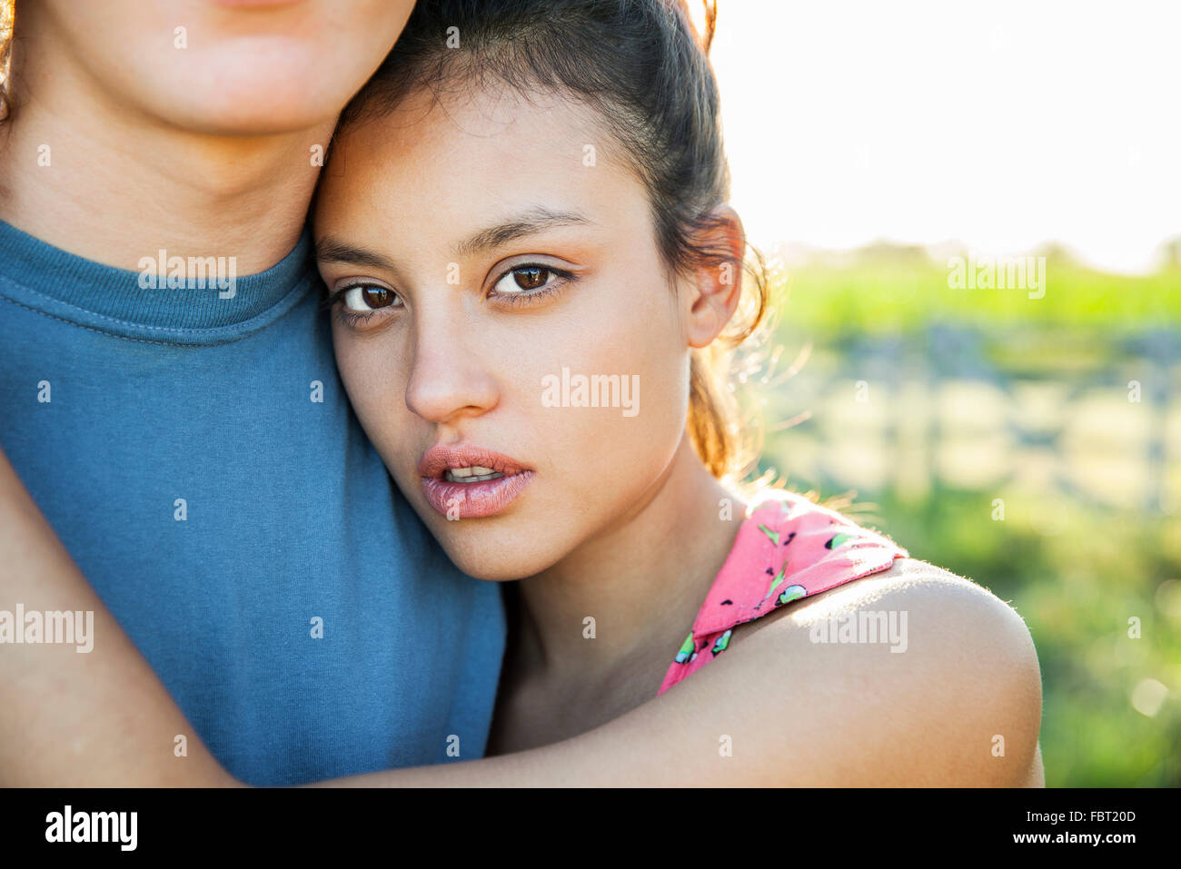 Giovane donna abbracciando il fidanzato, ritratto Foto Stock