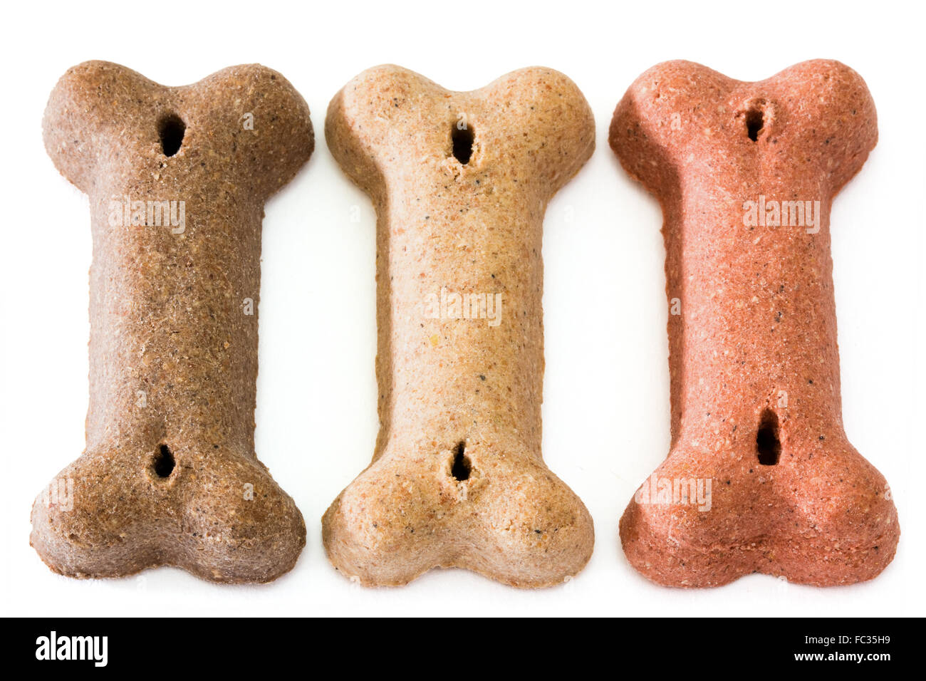 Tre biscotti di cane Foto Stock