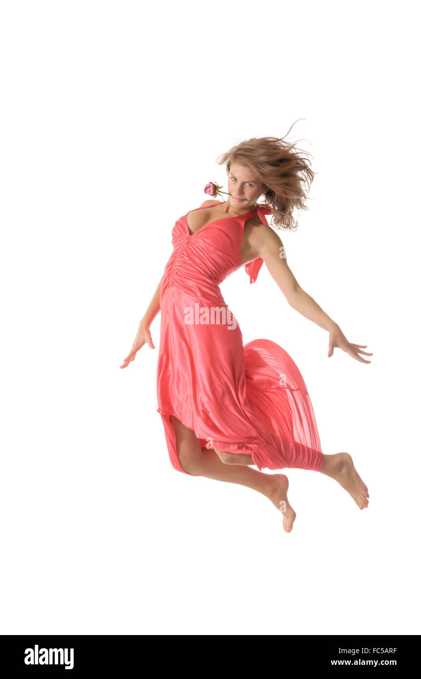 Bella giovane donna con fiore salta Foto Stock