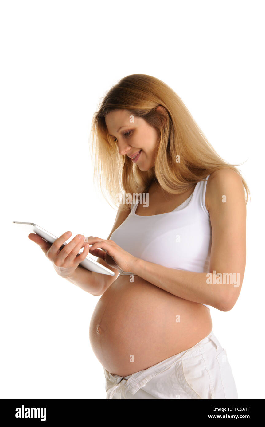 Donna incinta Tablet PC Foto Stock