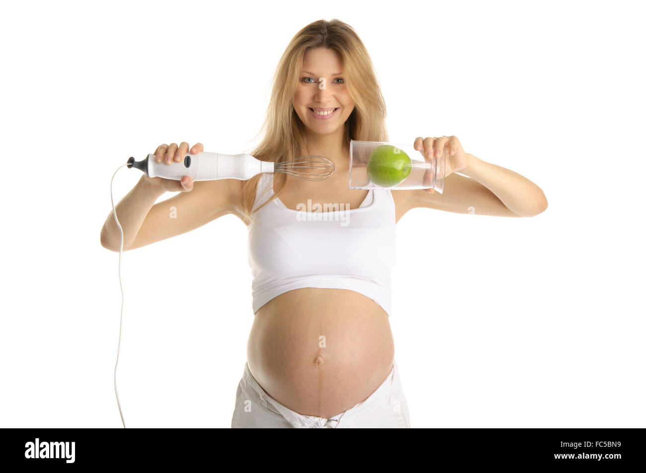 Donna incinta con un frullatore e Apple Foto Stock