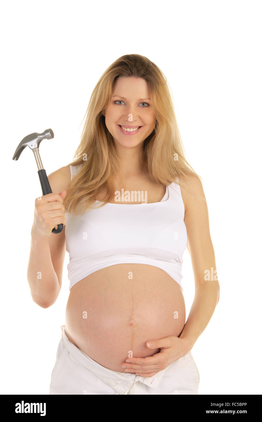 Felice donna incinta con un martello, Foto Stock