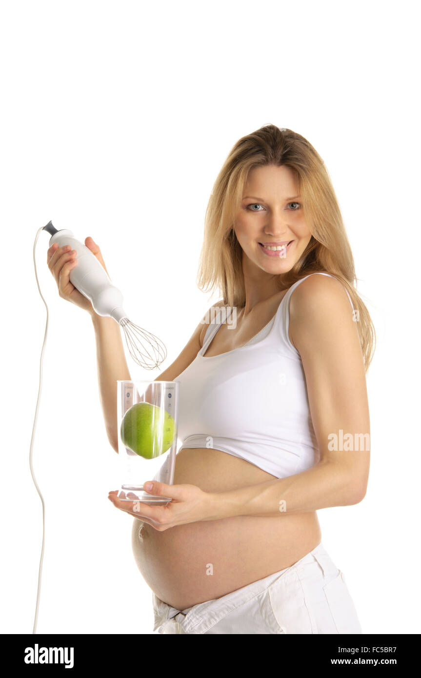 Donna incinta con un frullatore e Apple Foto Stock