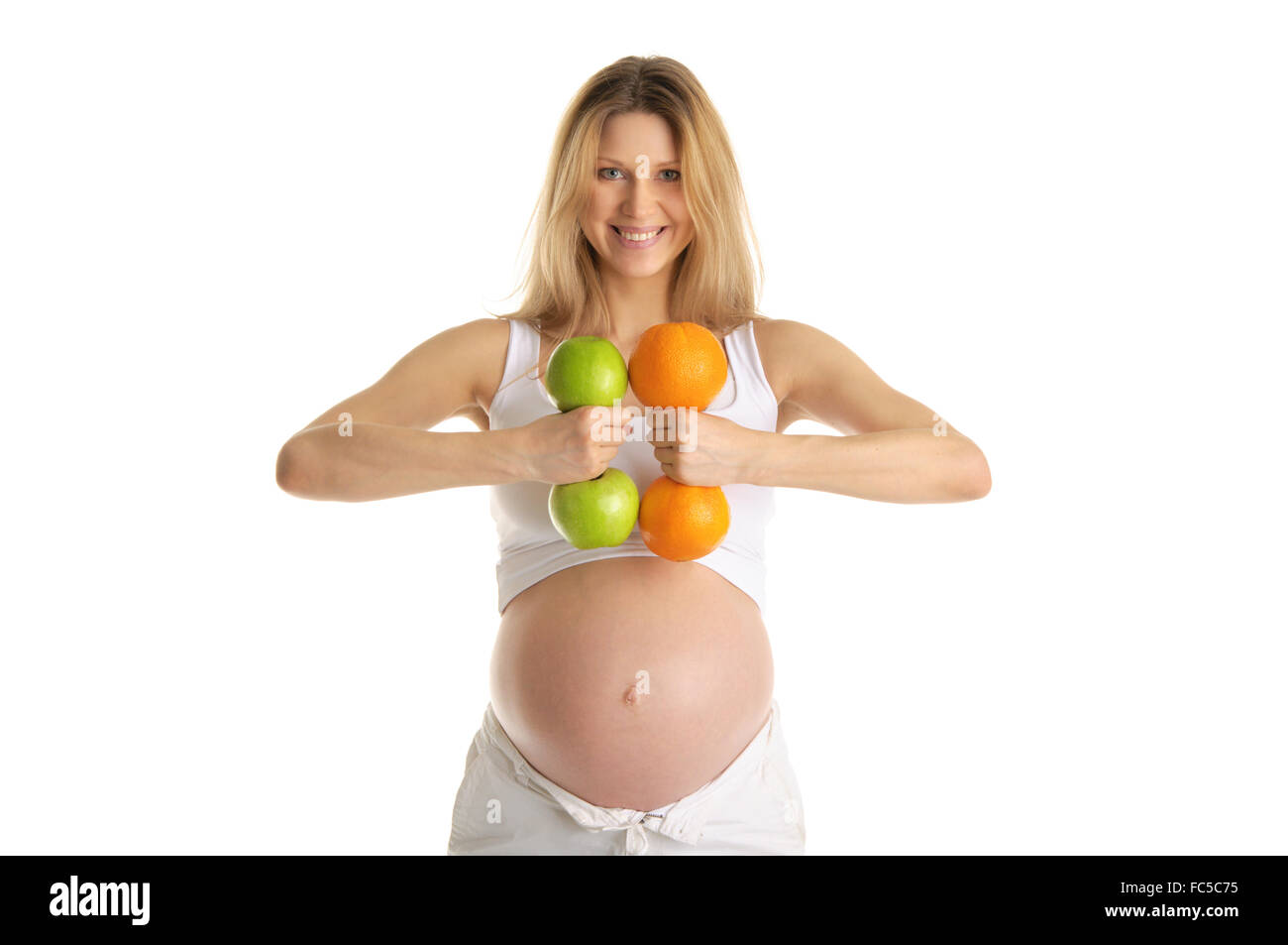 Donna incinta coinvolta nel fitness manubri Foto Stock