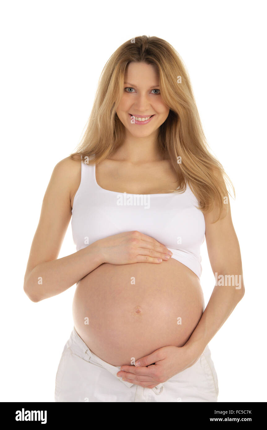 Donna incinta stringe le mani su stomaco Foto Stock
