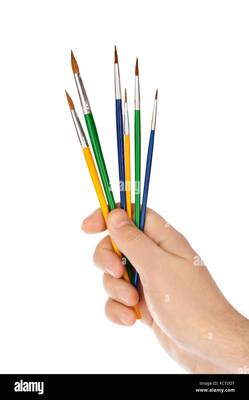 Mano con pennelli multicolore Foto Stock