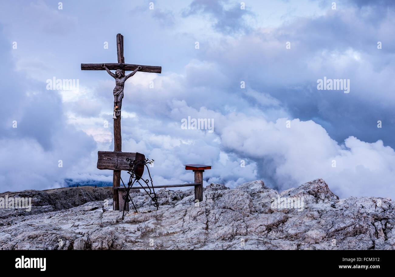 Croce di legno, crocefisso, sul piccolo Lagazuoi. Nuvole, cielo drammatico al tramonto. Le Dolomiti. Alpi Italiane. Europa. Foto Stock