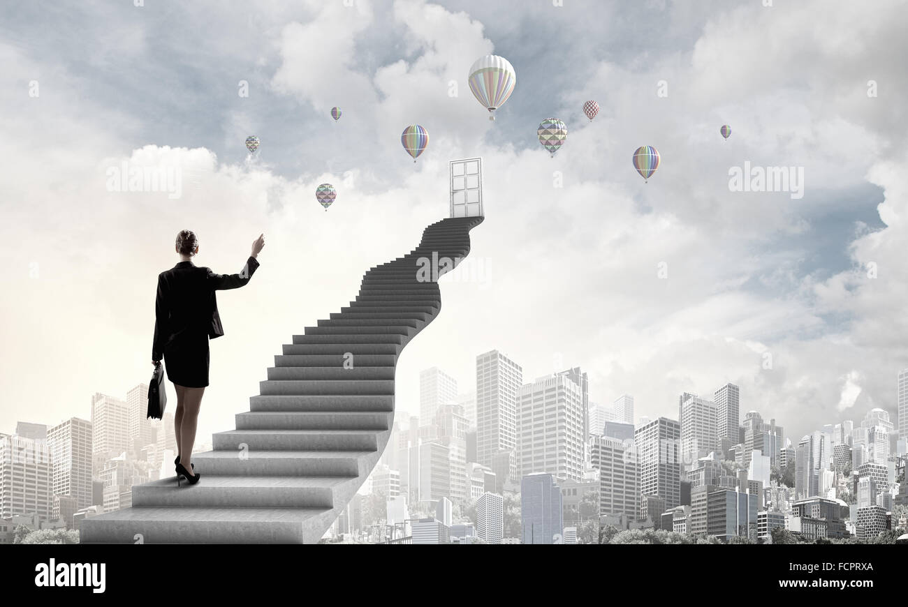 Imprenditrice a piedi fino alla scalinata porta in cielo Foto Stock