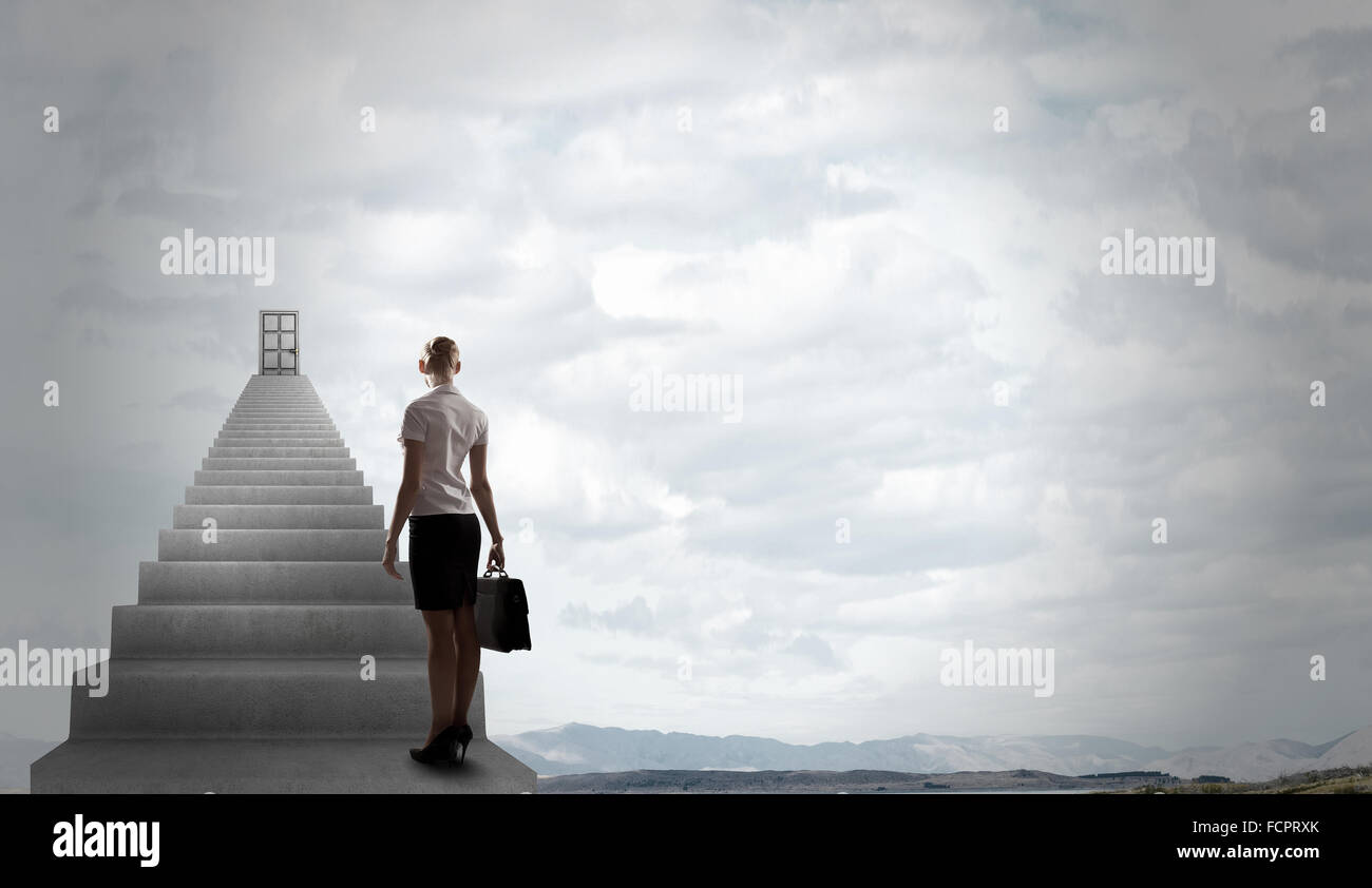 Imprenditrice a piedi fino alla scalinata porta in cielo Foto Stock