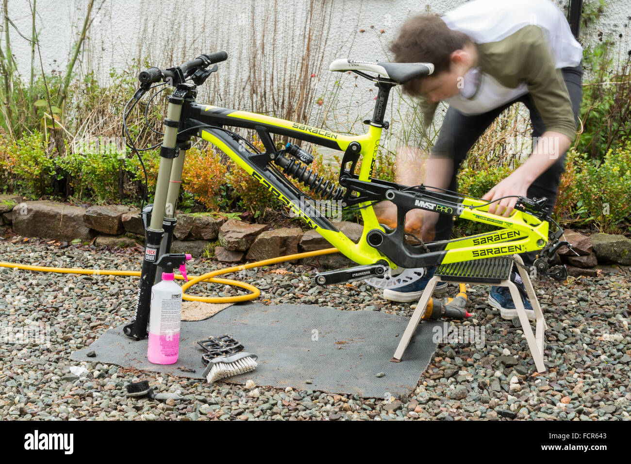 Adolescente di pulizia e di costruire in discesa in mountain bike Foto Stock