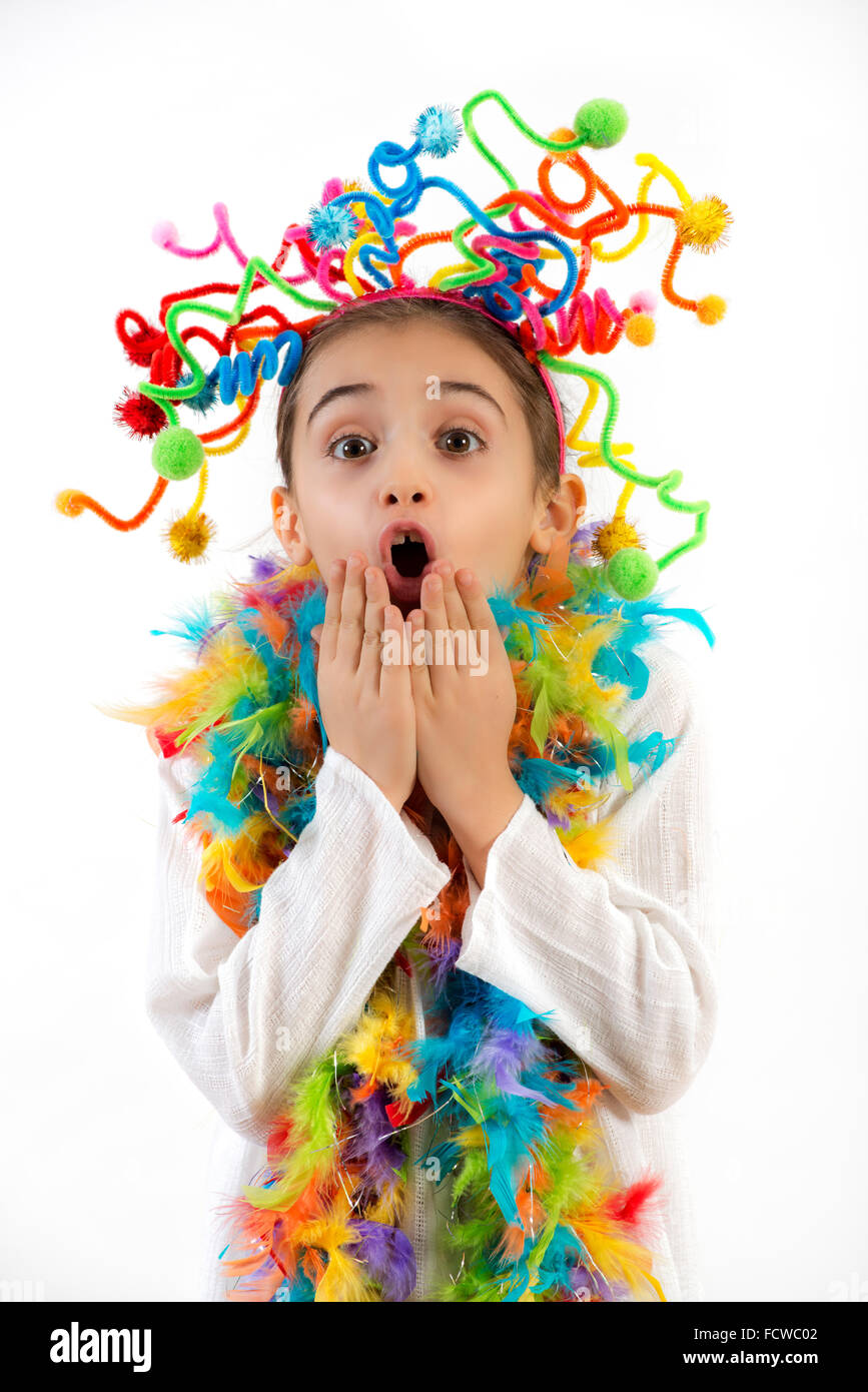 Giocoso bella ragazza in un colorato costume partito con parentesi fiori luminosi nei suoi capelli Foto Stock