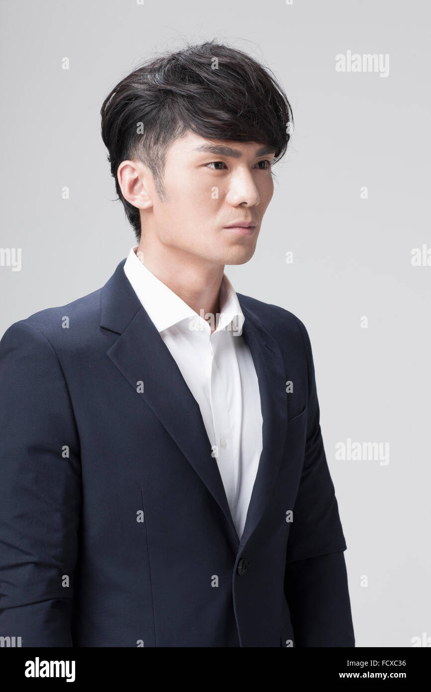 Uomo in abito nero con lo sguardo fisso sul lato Foto Stock