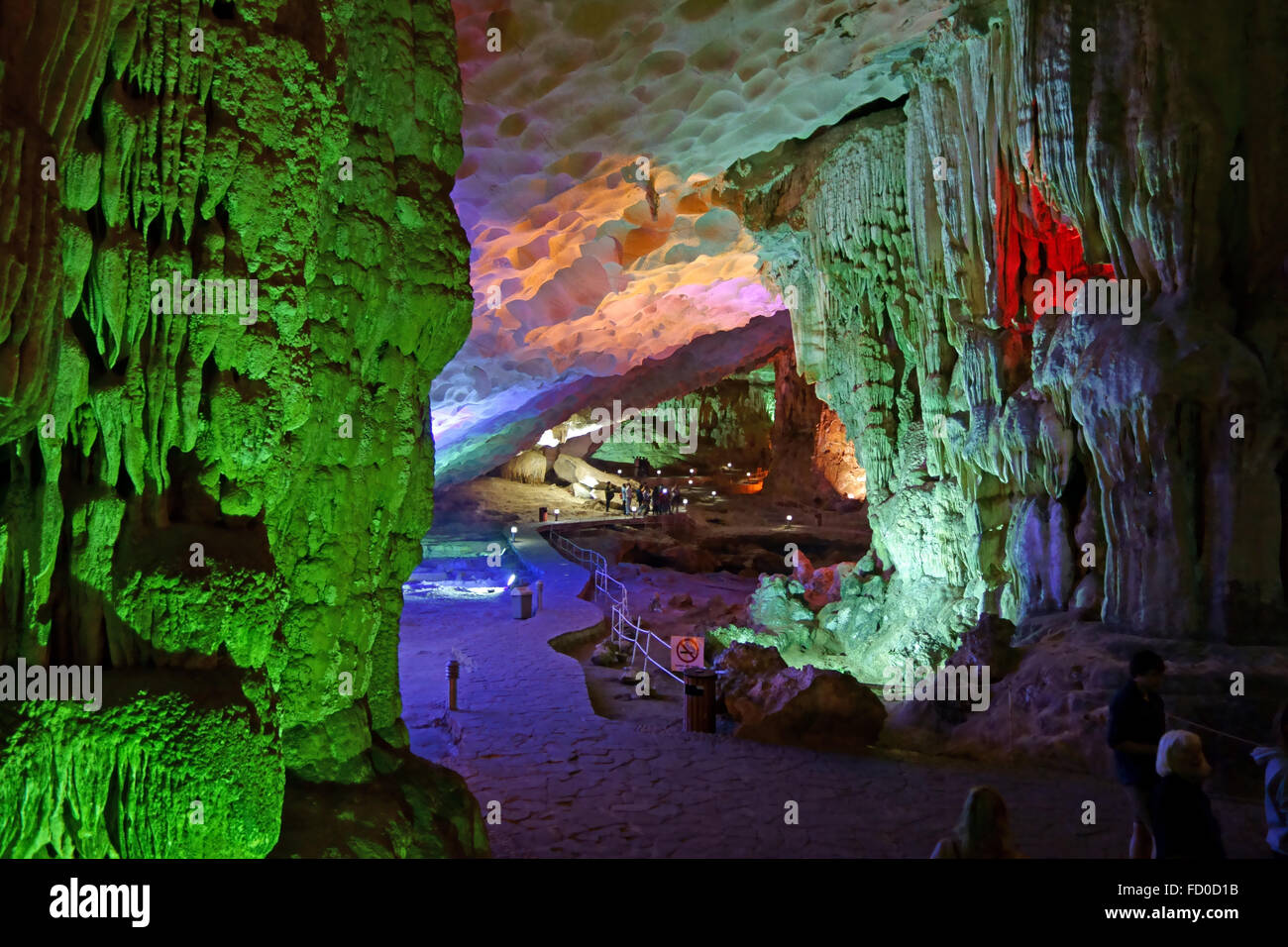 I visitatori in una grande caverna con formazioni stalattitiche e stalagmitiche più, Dau Go grotta, in calcare carso in Halong Bay, Vietnam Foto Stock