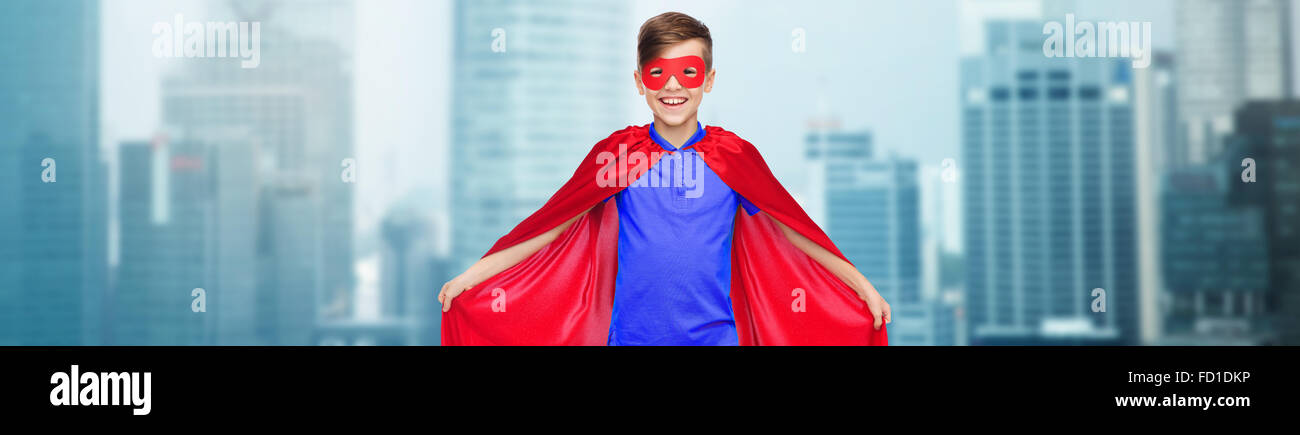 Ragazzo in rosso super hero cape e maschera Foto Stock