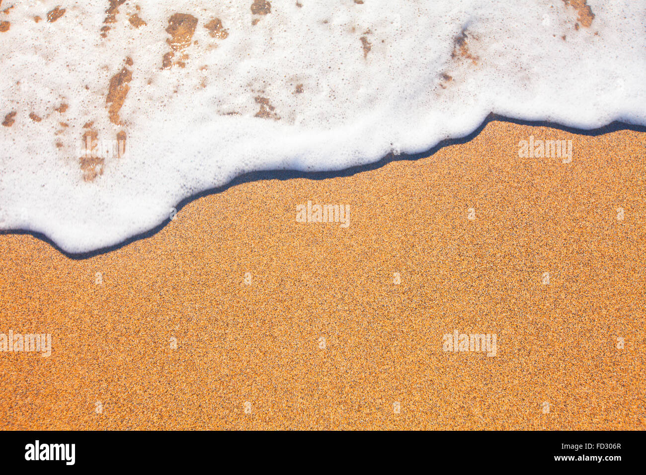 Sabbia e sfondo d'onda Foto Stock