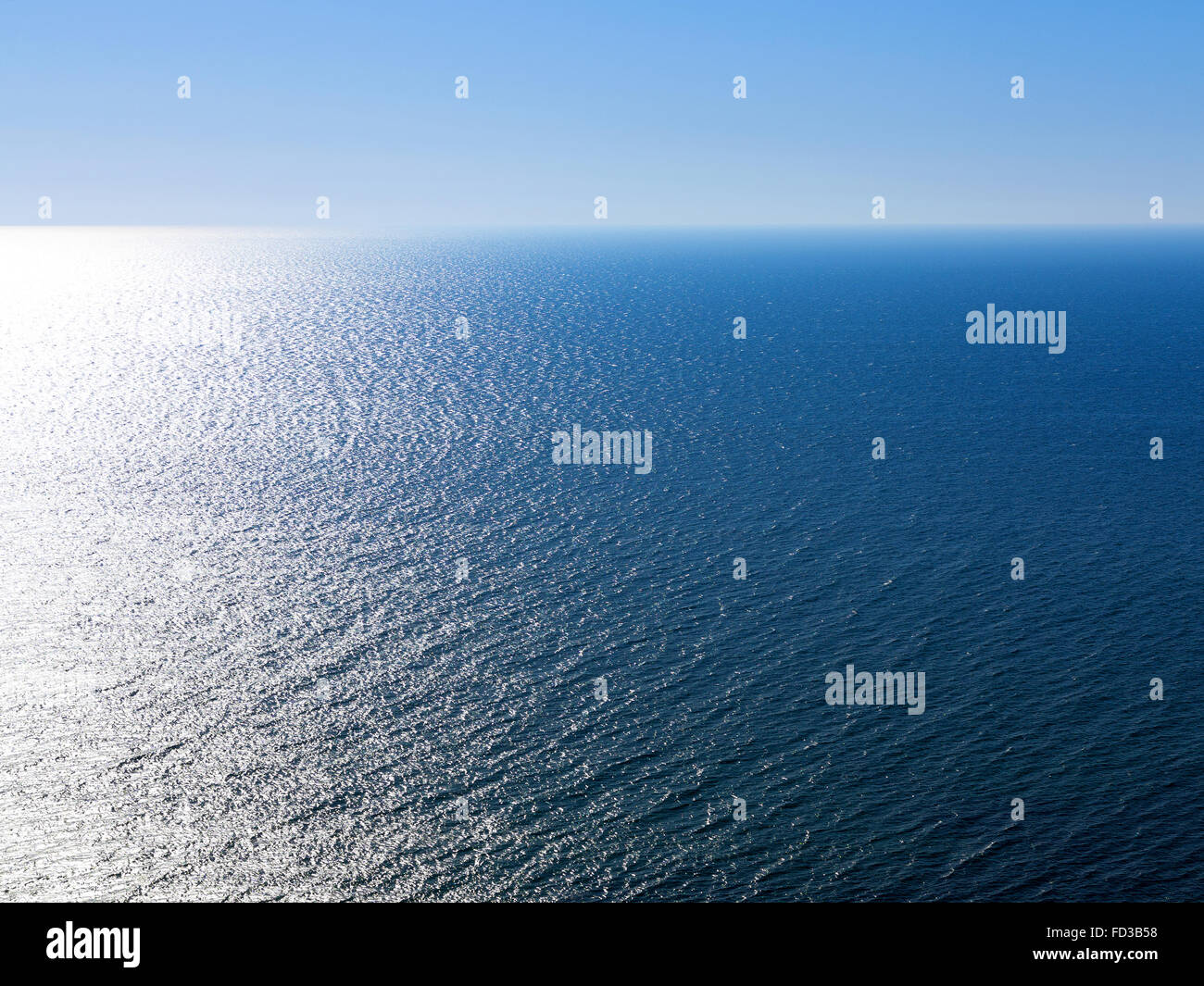 Blu sullo sfondo del paesaggio della superficie del mare al mattino Retroilluminato con luce del sole in una vasta gamma di luminosità. Per creative desig Foto Stock