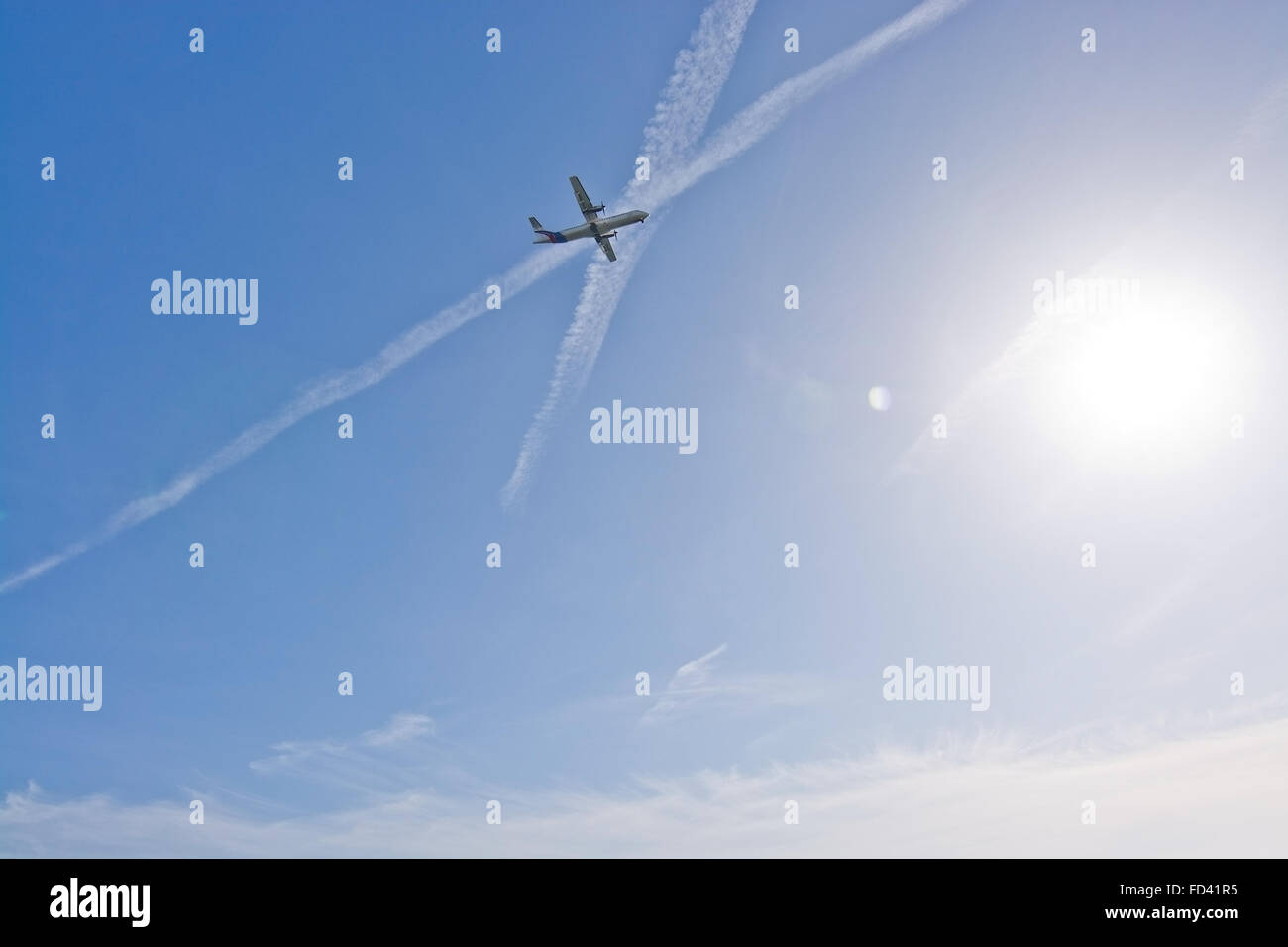 Piano di elica da Palma scende in cielo nebbioso con contrails su Playa den Bossa su un soleggiato inverno mattina Foto Stock