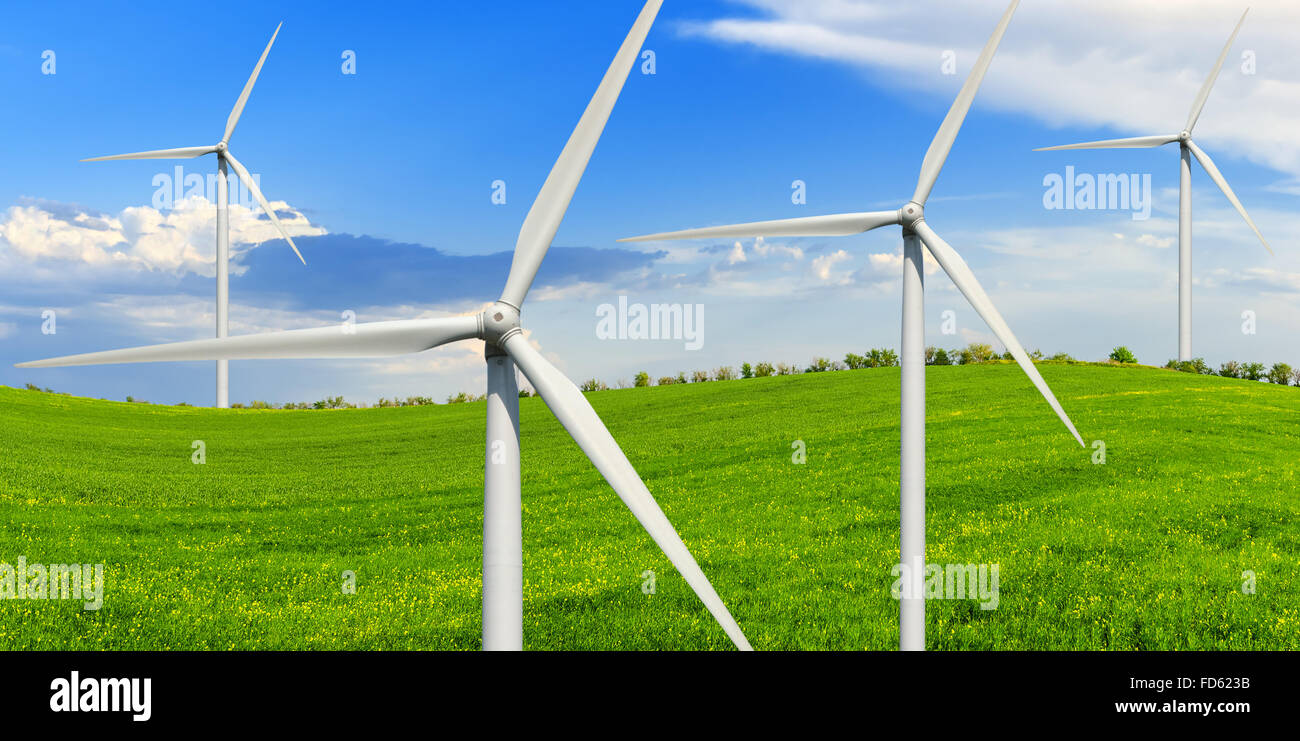 La molla giornata di sole su un verde prato con turbine eoliche. Fonti di energia alternative. Foto Stock