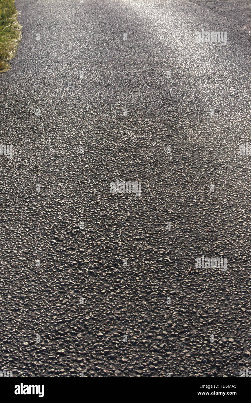 Struttura grigio della strada asfaltata in luce posteriore Foto Stock