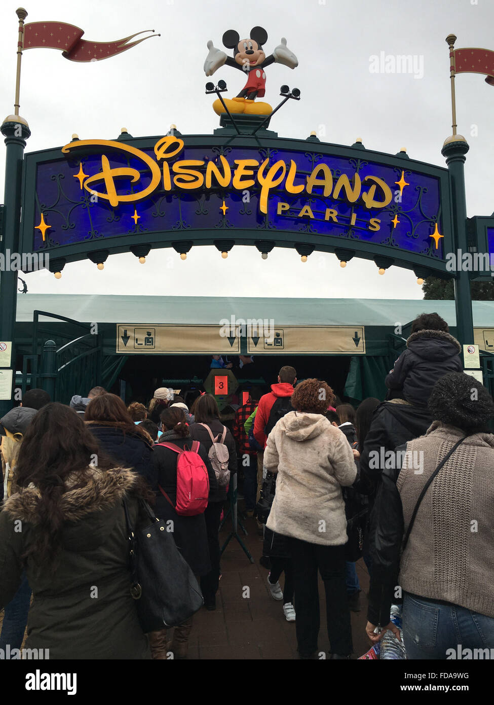 I visitatori di Disneyland Paris coda per avere le loro borse scansionato all'ingresso. Immagine: Scott Bairstow/Alamy Foto Stock