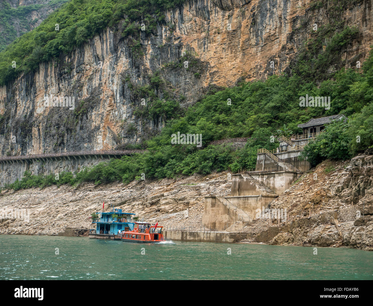 Una fermata di traghetto sul torrente Shennong un affluente del fiume Yangtze con alte scogliere calcaree Foto Stock