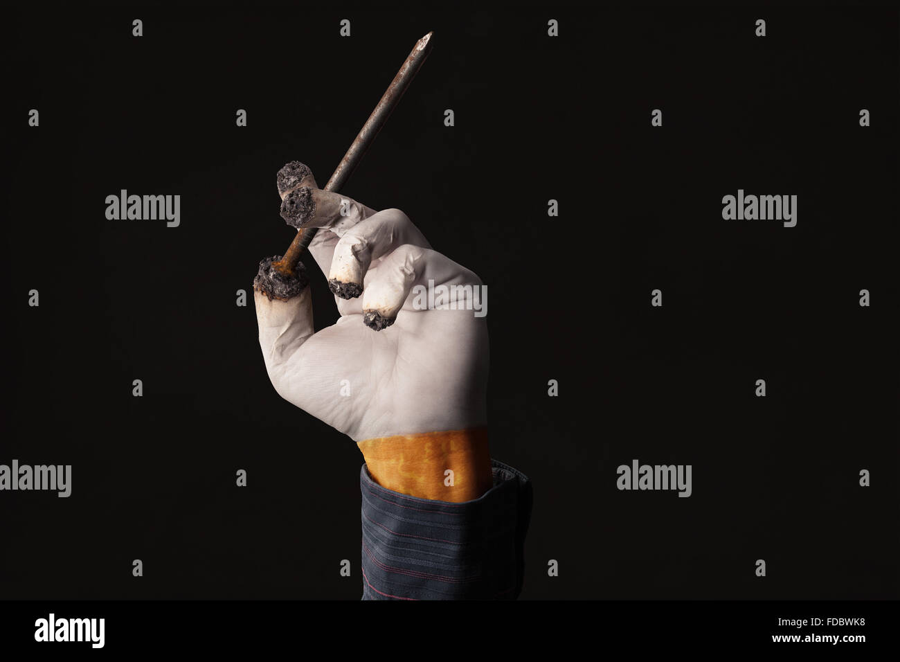 I fumatori mano trattiene una bara chiodo come una sigaretta Foto Stock