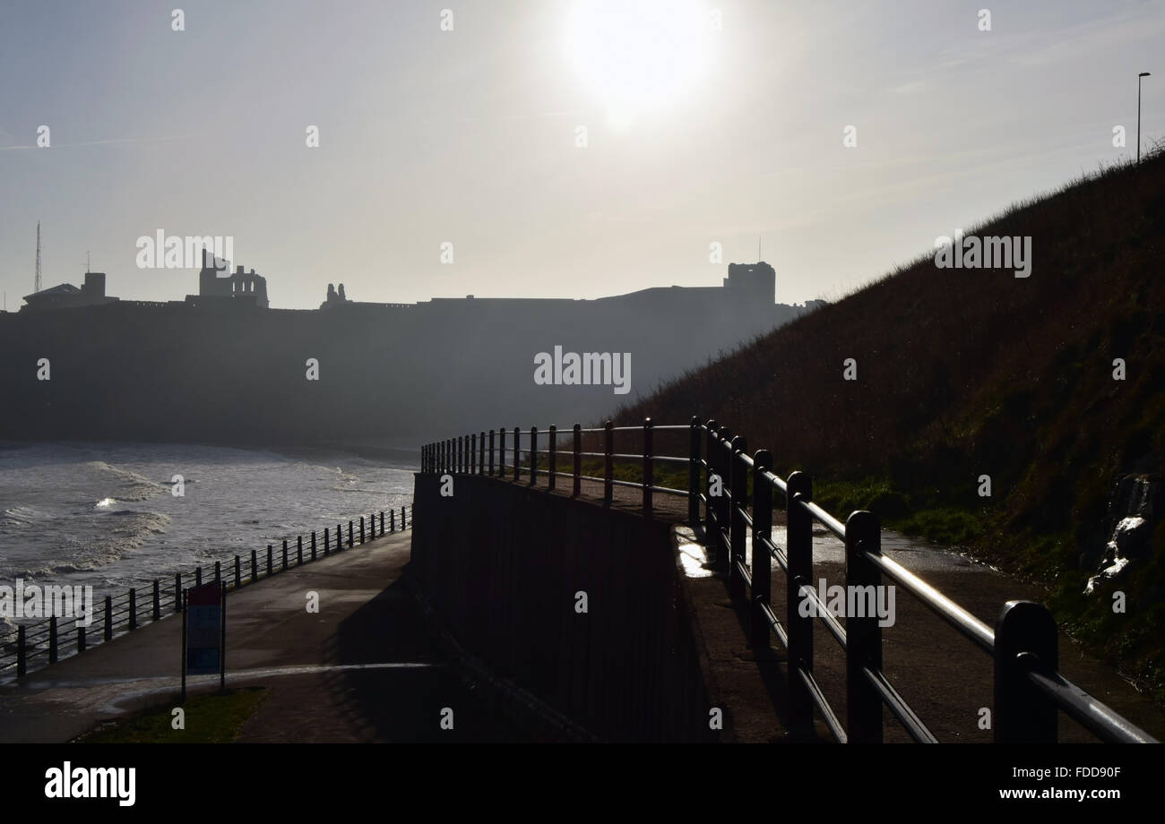 Priorato di Tynemouth in silhouette in background con il lungomare e le ringhiere in primo piano Foto Stock