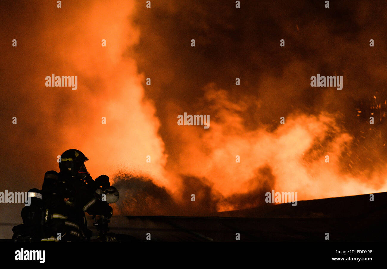Mosca, Russia. 30 gen, 2016. Vigile del fuoco di spegnere un incendio di una fabbrica a Mosca, Russia, a gennaio 30, 2016. Almeno 8 persone sono state uccise in un incidente di incendio di una fabbrica a Mosca il sabato sera. © Sputnik/Xinhua/Alamy Live News Foto Stock
