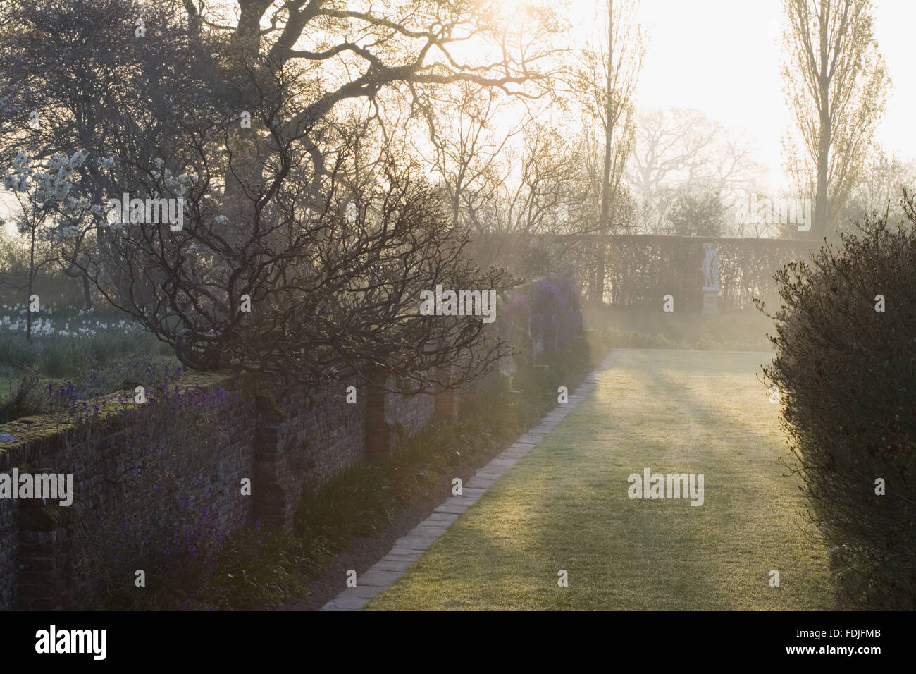 Il fossato a piedi all'alba presso il castello di Sissinghurst giardino, vicino a Cranbrook, Kent. Foto Stock