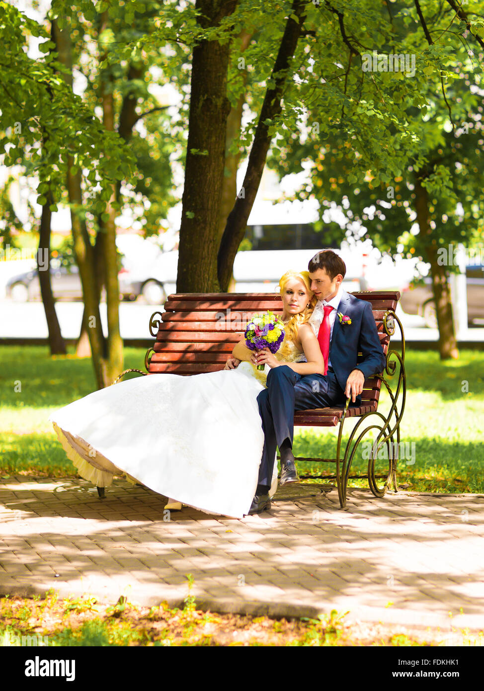 Sposa e lo sposo sul banco in un parco Foto Stock