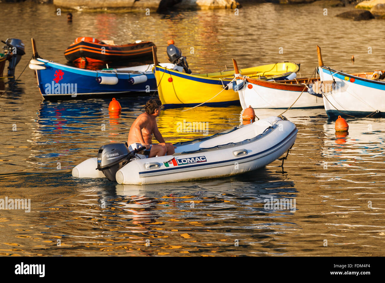 Un pescatore sulla sua barca tornando al porto di Vernazza, Cinque Terre National Park, Liguria, Italia. Foto Stock