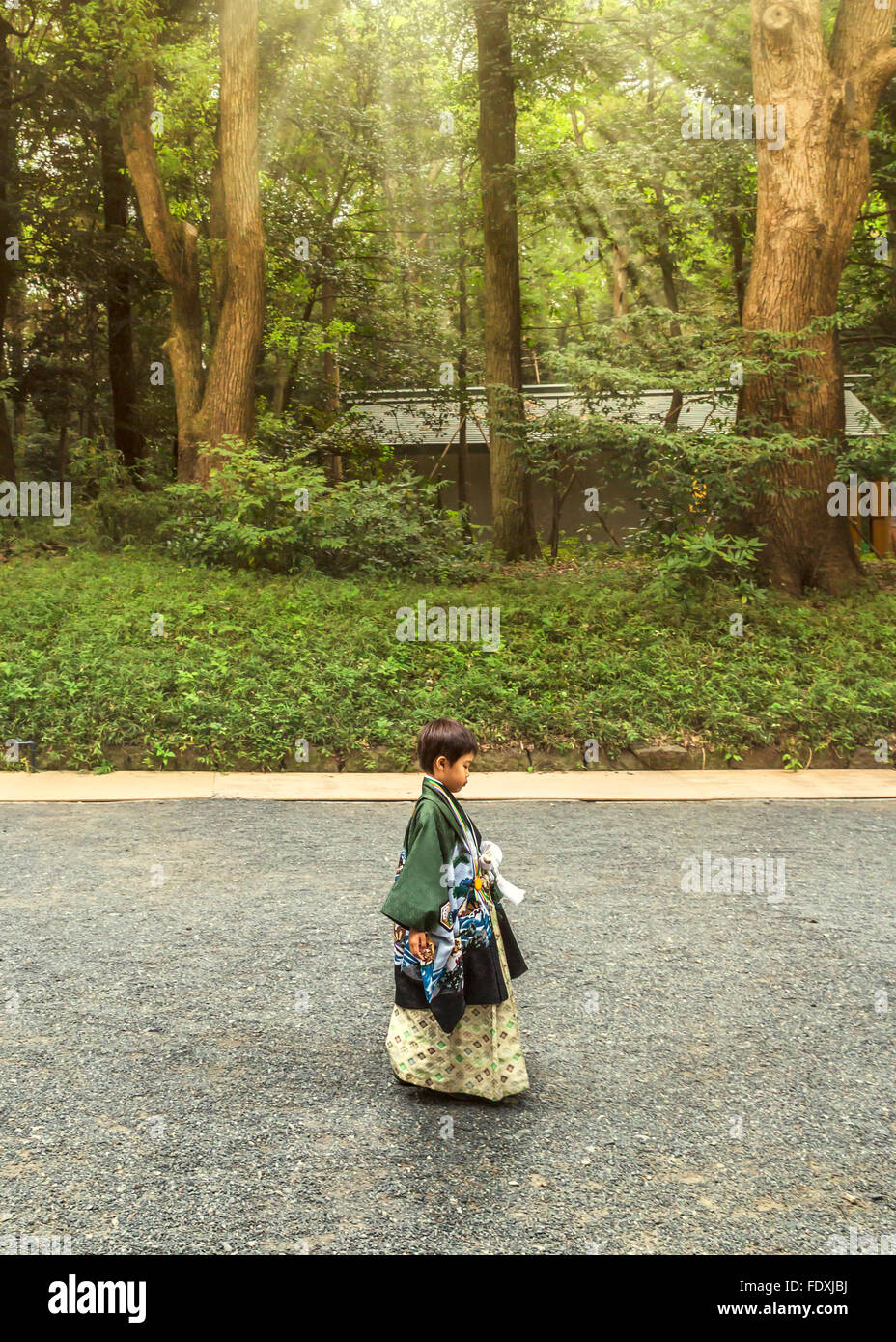 Ragazzo giapponese camminare da solo al mattino in giardino Foto Stock