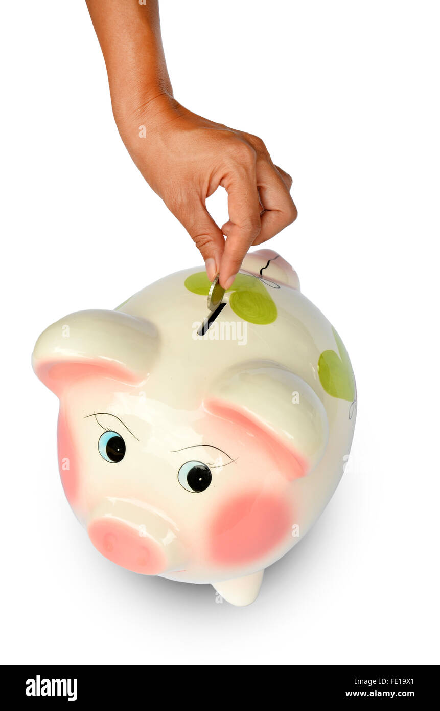 Salvadanaio e la mano con moneta isolato su sfondi bianchi Foto Stock