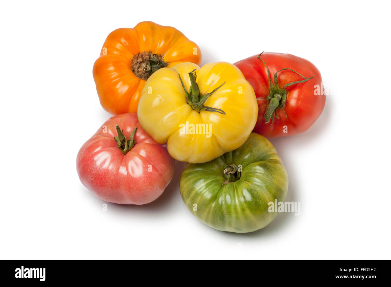La diversità di tutta la bistecca di manzo pomodori su sfondo bianco Foto Stock