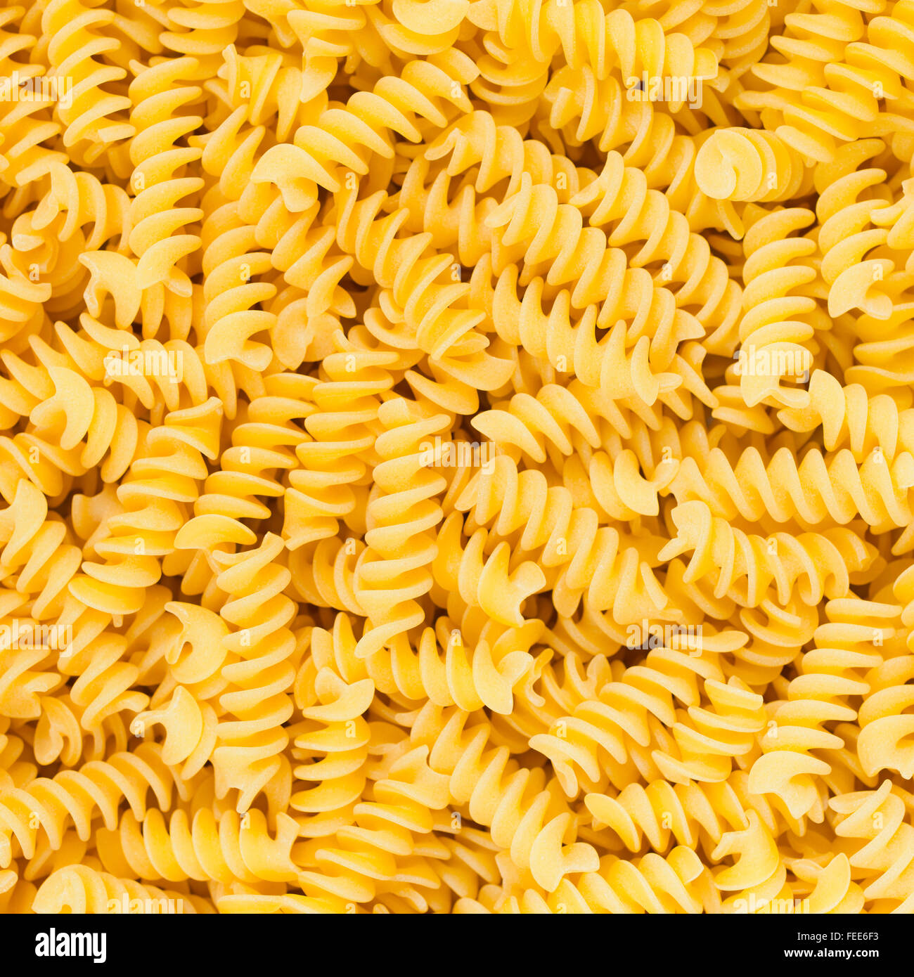 Fusilli italiano Rotini o a forma di elica Maccheroni alimenti crudi o sfondo texture close up Foto Stock