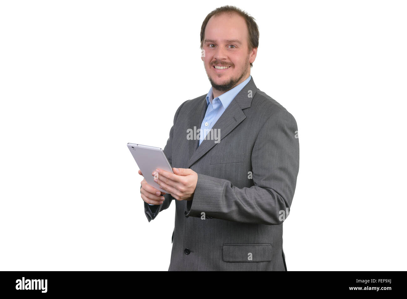Uomo grigio scuro suit sorridente azienda computer tablet Foto Stock