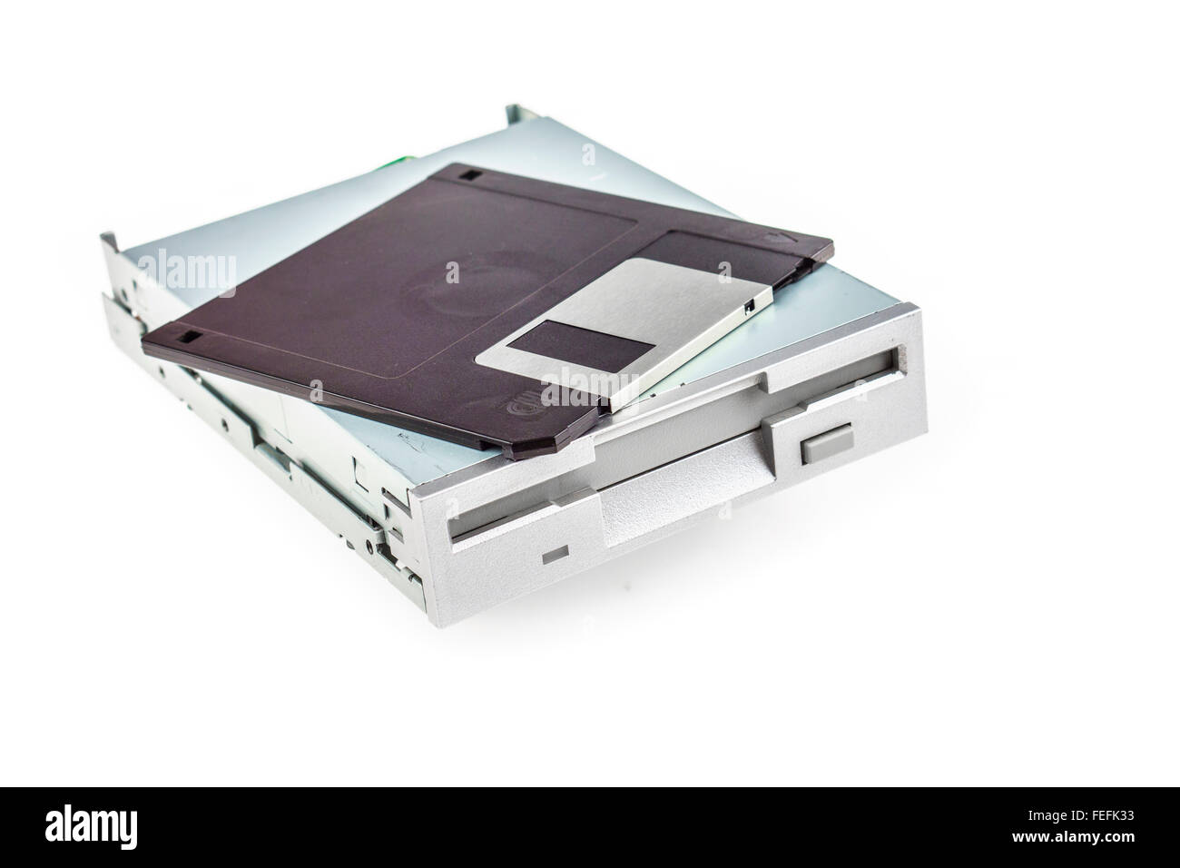 Unità disco floppy e il dischetto isolato su bianco Foto Stock