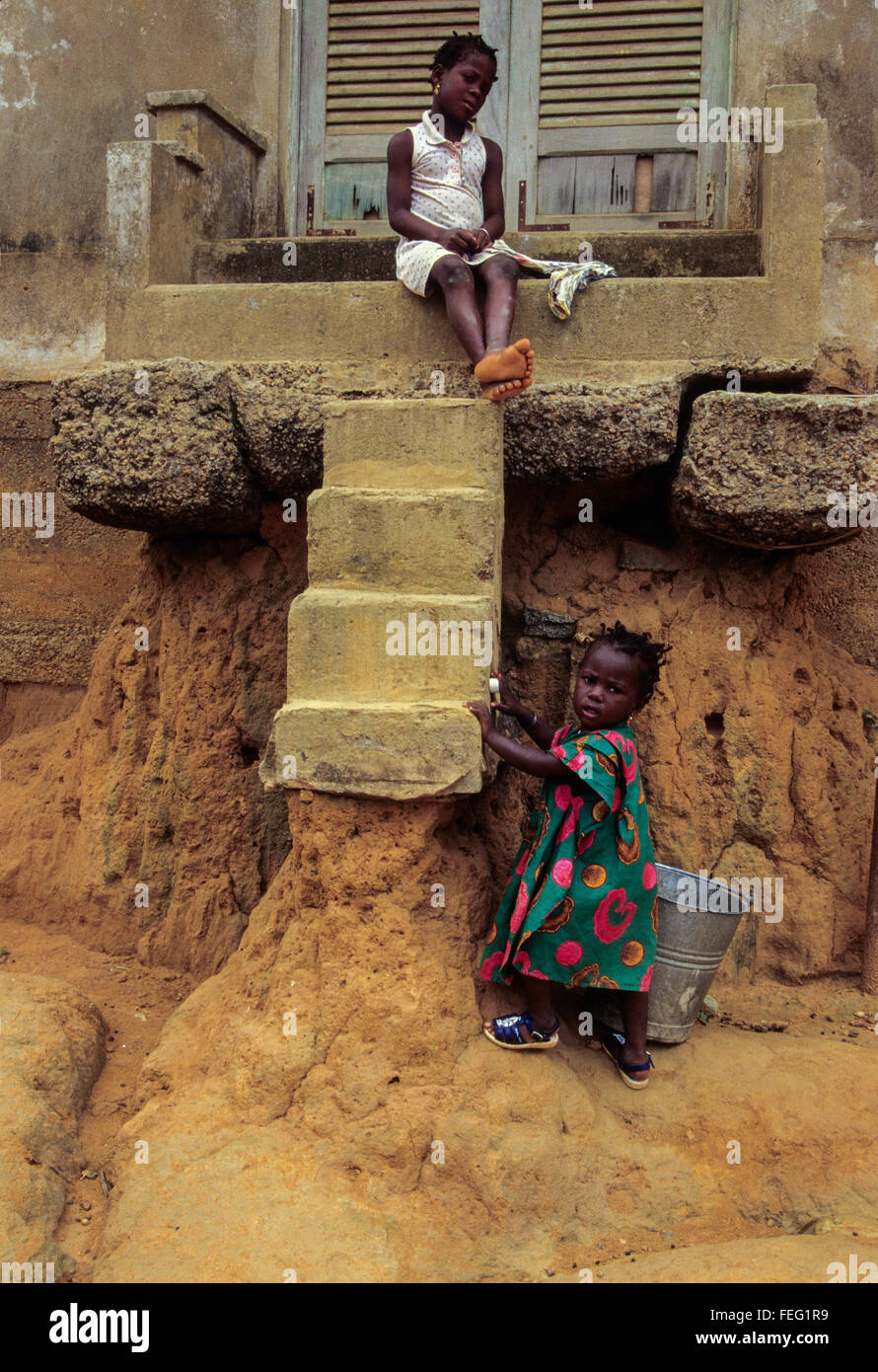 Sassandra, Costa d'Avorio (Costa d Avorio). Erosione provocata dalle pesanti piogge tropicali rendono difficile per i bambini per raggiungere la casa passi . Foto Stock