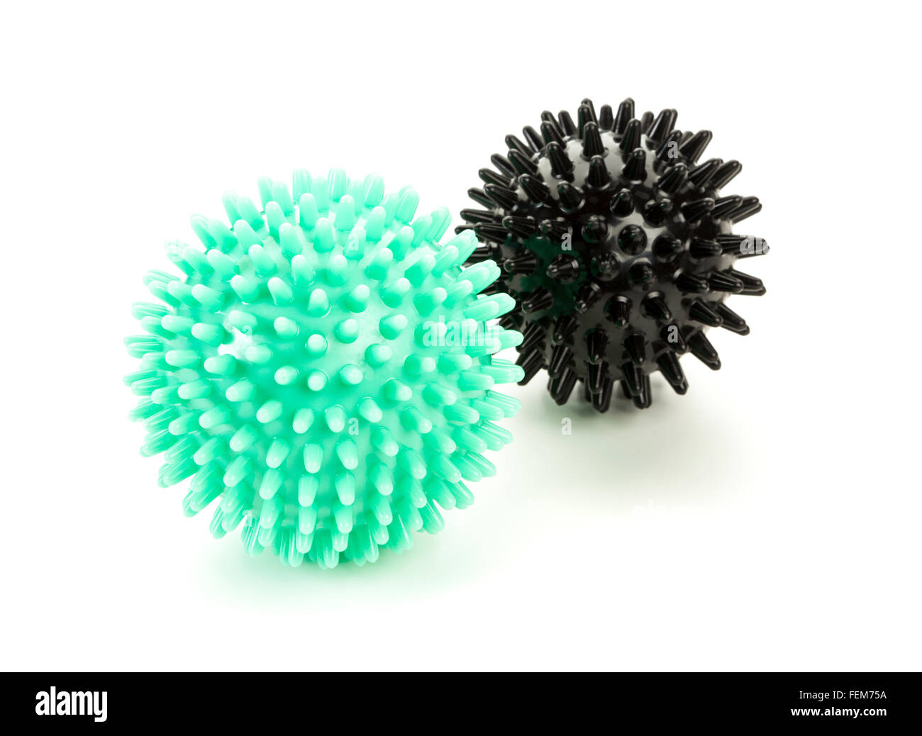 Verde e nero palle massaggi su sfondo bianco Foto Stock