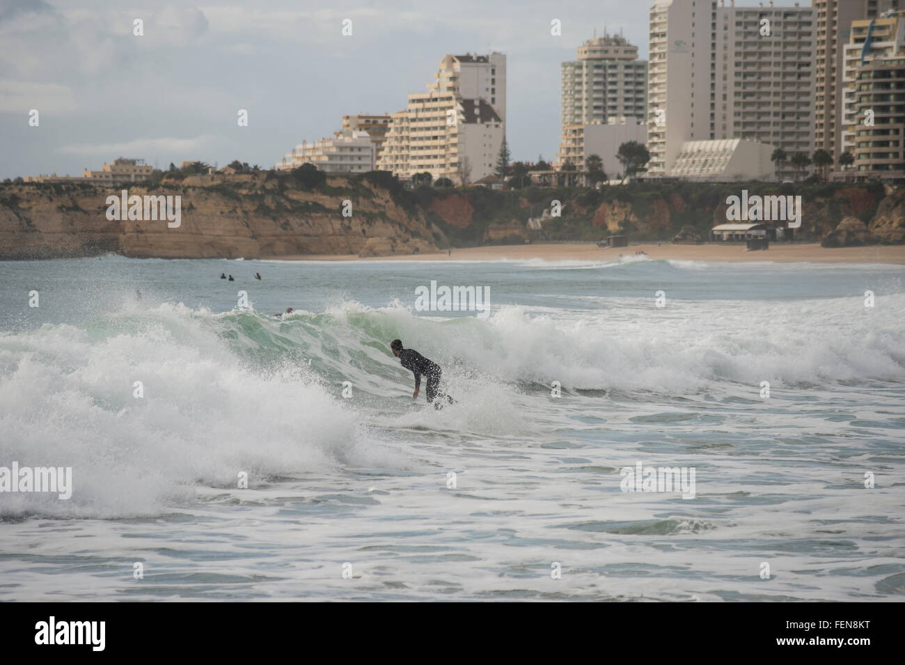 Surfer cavalcare le onde in Praia da Rocha in Portogallo Foto Stock
